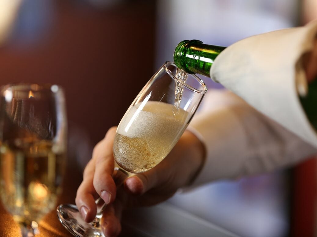 Bartender pouring Champagne into glass