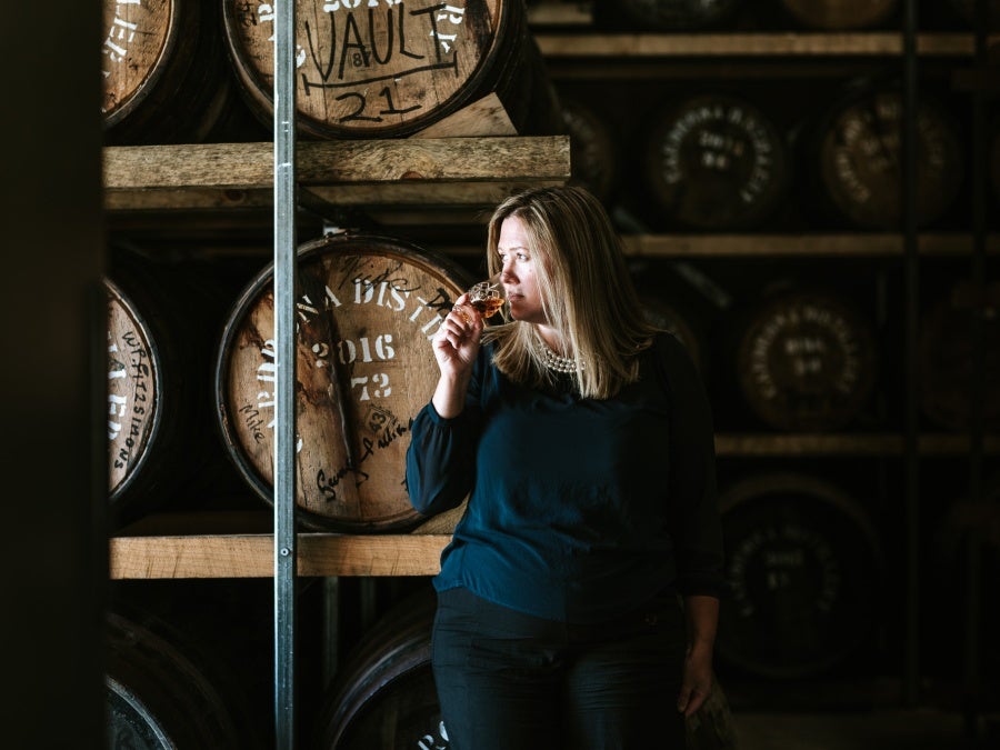 Desiree Reid sniffs a glass of whiskey in her distillery in Cardrona Valley New Zealand