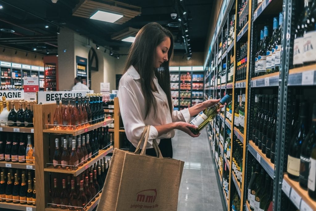 Woman in store shopping for wine