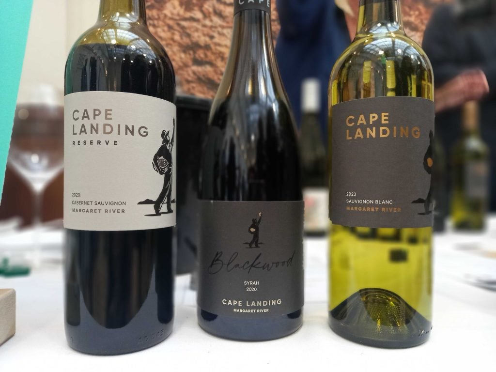 Three wines stand on a table with blurry background, close up on labels reading Cape Landing