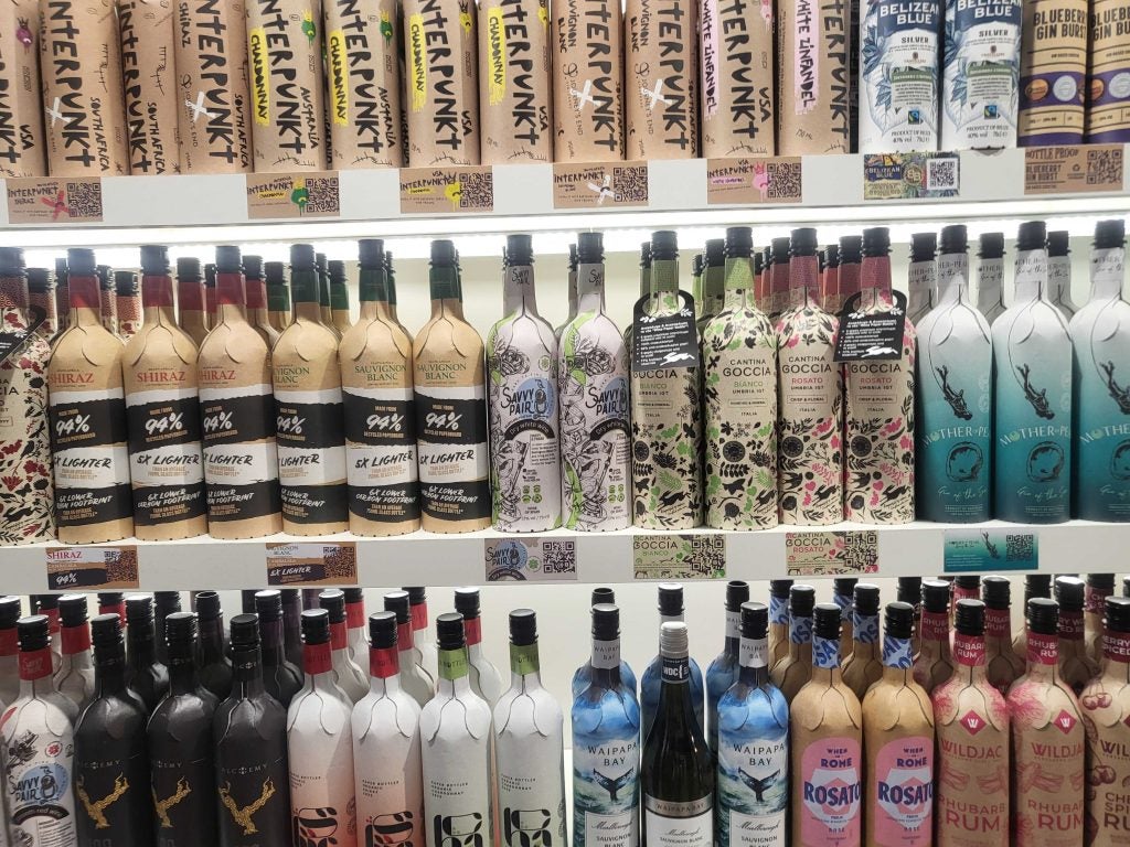 Shelves full of colourful paper wine and spirits bottles
