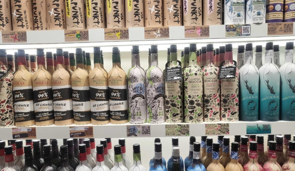 Shelves full of colourful paper wine and spirits bottles