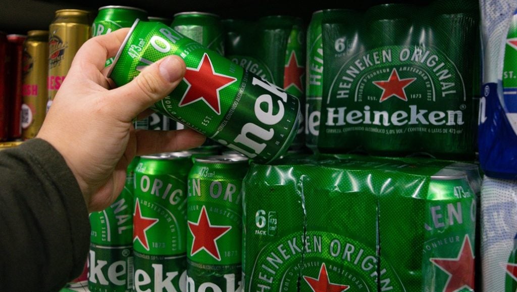 Man picking up can of Heineken in supermarket, 17 July 2023