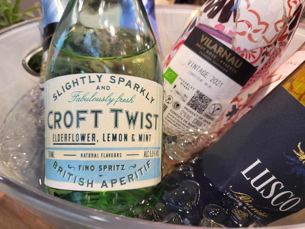 Three bottles in an ice tub, two wines and one low-alcohol spritz product