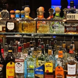 JUNEAU, US - Oct 03, 2024: A well-stocked bar with various liquors on glass shelves.