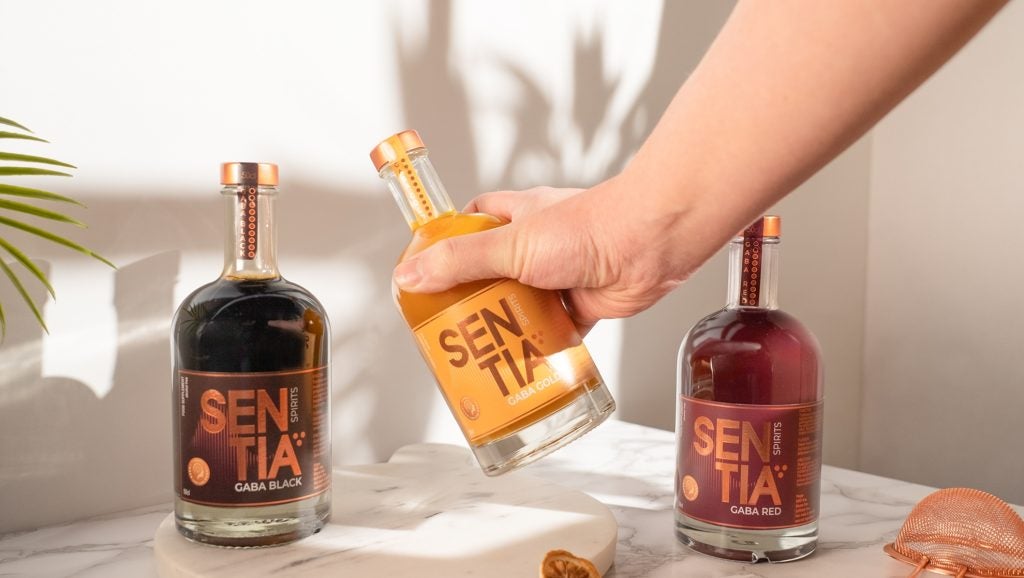 A person picking up a bit of Sentia Spirits’ Gaba Gold non-alcoholic drink